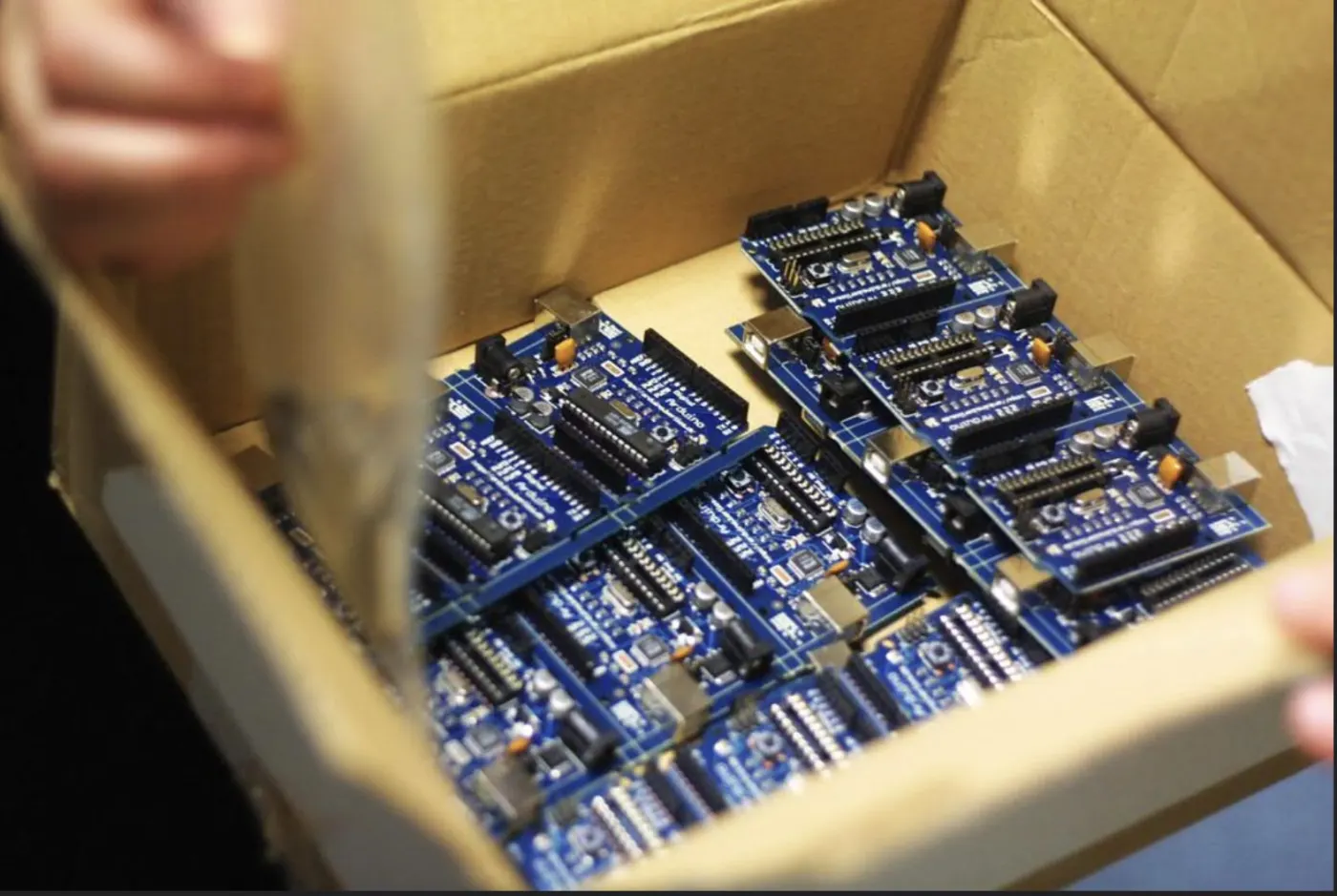 Blue electronic boards laid out in a box