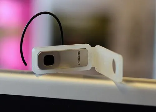 A modified bluetooth earbud extended by a white 3D-printed part