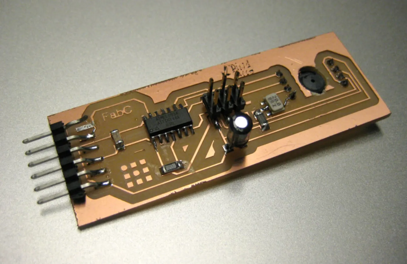 A printed circuit board on wood forming the body of a camera, with its connectors