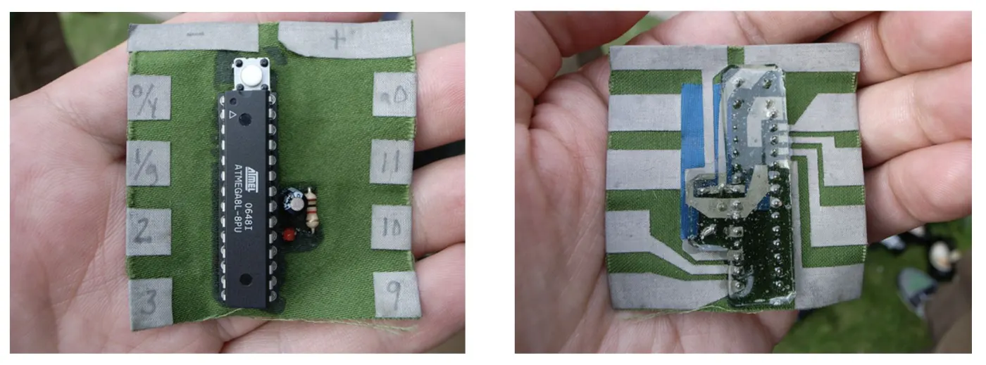 Two green circuit boards held in the hands