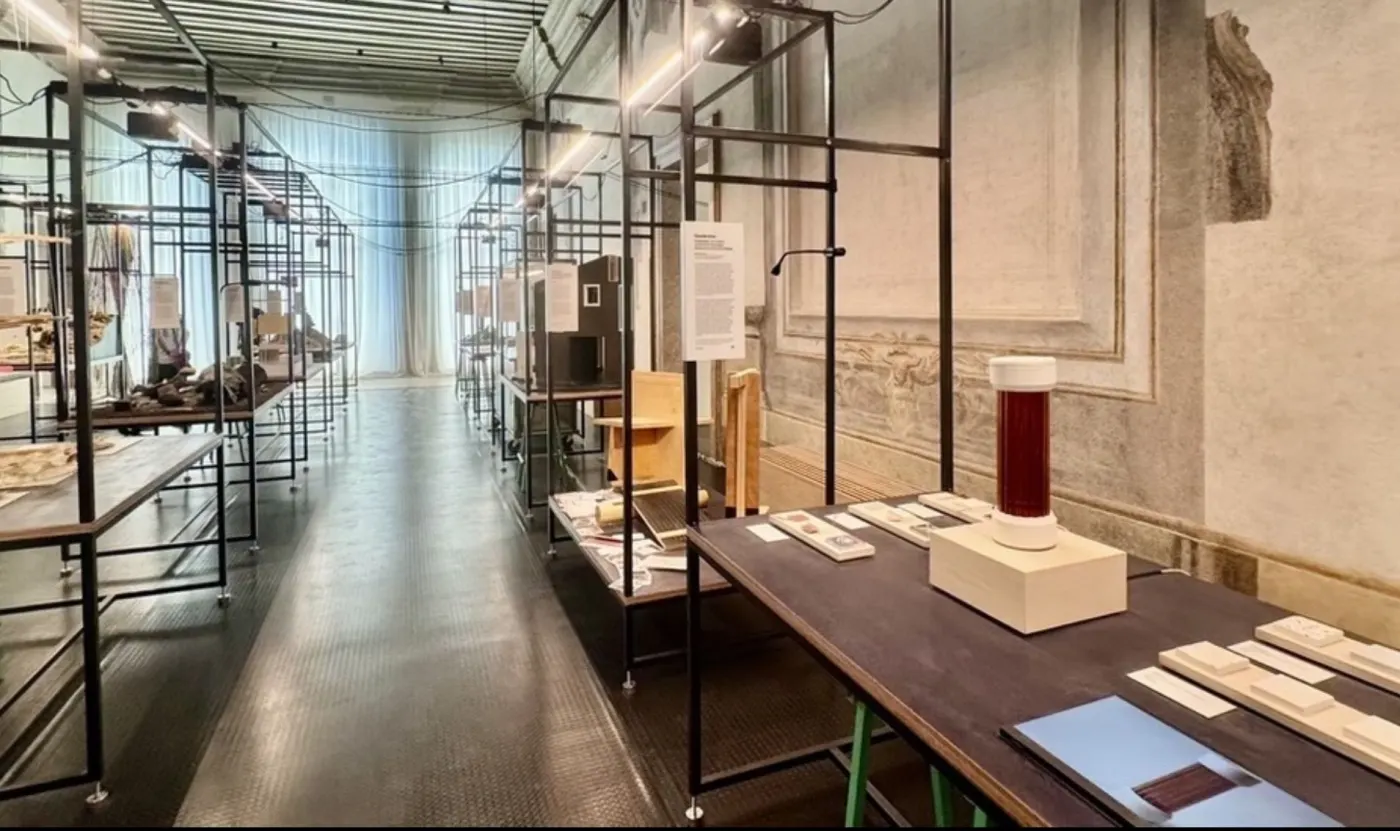 Vaulted gallery of a Venetian palazzo, exhibition tables in a row