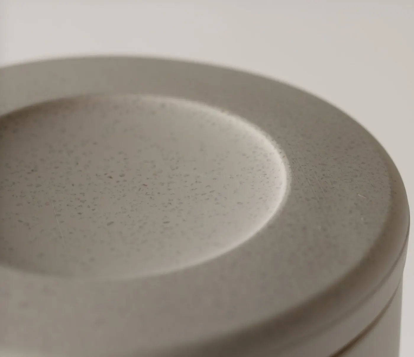 Macro photograph of a speckled grey geopolymer surface