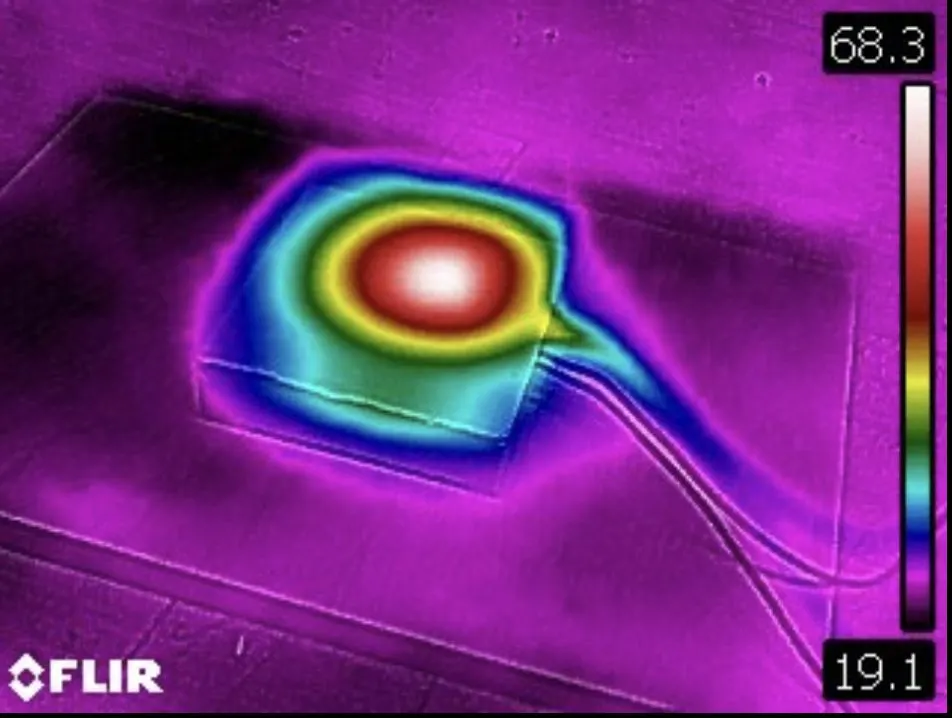 False-colour thermal image with a bright hotspot at the centre