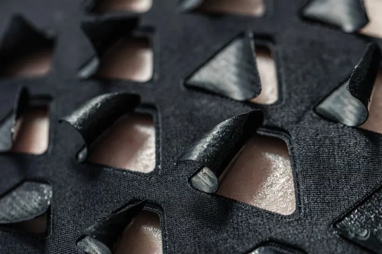 Close-up of a dark textile covered in raised scales