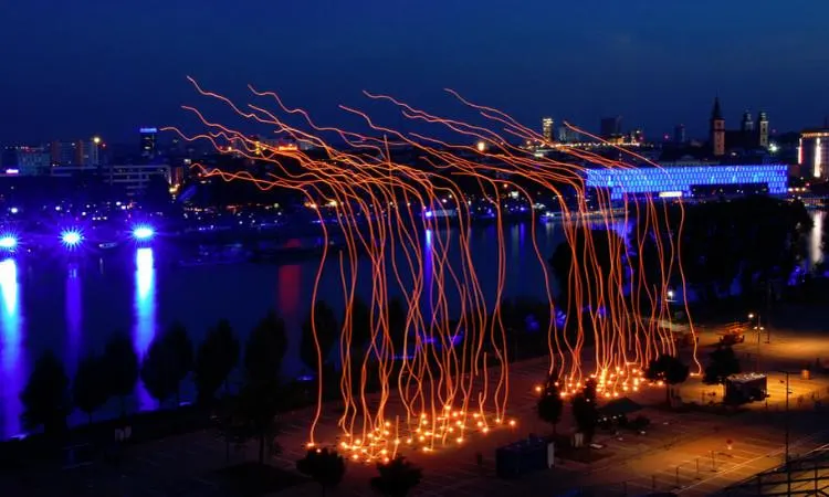 Night-time light installation, long orange fibres hanging
